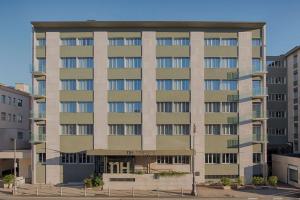 a large apartment building in a parking lot at NH Trieste in Trieste
