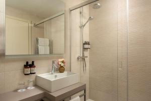 a bathroom with a sink and a shower at NH Trieste in Trieste