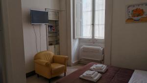 a bedroom with a bed and a chair and a window at Dimora San Leucio in Lecce