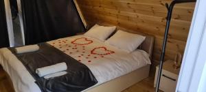 a bed with two hearts painted on it at A-frame evlər-I in Qusar