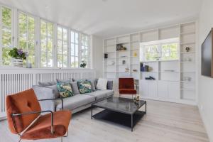 a living room with a couch and a table at Villa Falsterbo in Skanör med Falsterbo