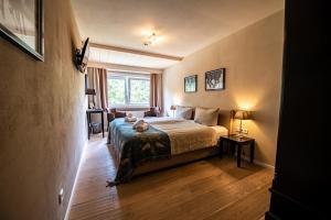 a bedroom with a bed and a window at Landhotel Flora & Fauna in Winterberg