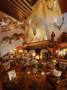 a living room with a large room with a fireplace at Hotel Jagdhof Glashütte in Bad Laasphe