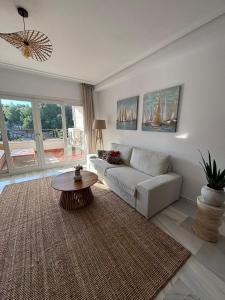 a living room with a couch and a table at Bella Calpe Luxury Apartment in Calpe