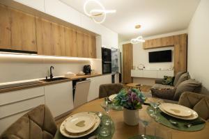 a kitchen and a living room with a dining table at Panoramic RESIDENCE in Baia Mare