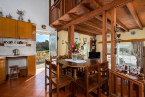 a kitchen and dining room with a wooden table and chairs at Yannis Place in Rhodes Town