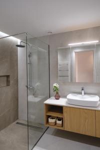 a bathroom with a sink and a shower at Olive Garden House in Gastourion