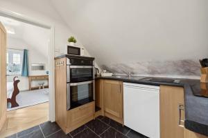 a kitchen with a sink and a stove top oven at Beautiful Country Apartment, rated Exceptional in Coventry