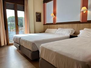 Postel nebo postele na pokoji v ubytování Hotel Pinomar
