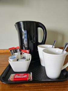 a tray with cups and bowls and a coffee pot at Dergfield House in Ballybofey +13 photos