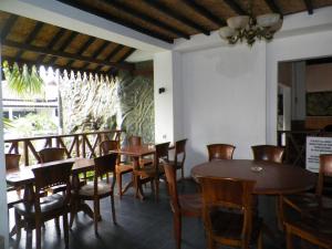 a dining room with wooden tables and chairs at Bladok Hotel & Restaurant in Yogyakarta