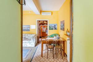 a living room with a table and a couch at LA CORTE DELLA CARLA - cozy home in the old court in Lierna