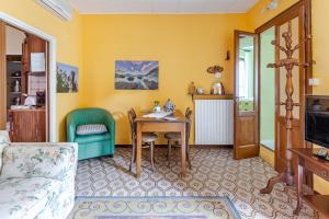 a living room with a table and a chair at LA CORTE DELLA CARLA - cozy home in the old court in Lierna