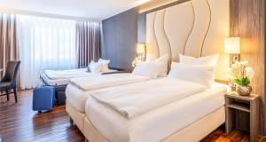 Postel nebo postele na pokoji v ubytování PLAZA Hotel Buchhorner Hof