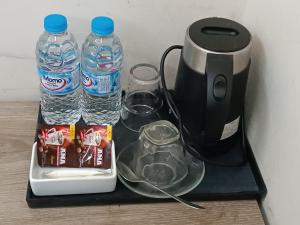 a black tray with two bottles of water and a blender at The Asteria Hotel Bogura in Bogra