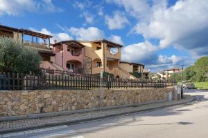 a fence in front of a house on a street at Residence Orizzonti app n 3 in Golfo Aranci
