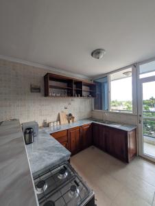 ダル・エス・サラームにあるPeninsula View by Nyumbani Apartmentsのコンロとカウンタートップのあるキッチン