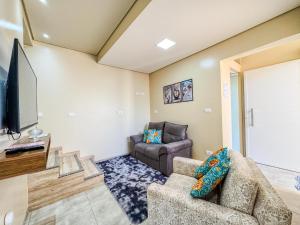 TV a/nebo společenská místnost v ubytování Encanto, conforto e praticidade em um só lugar
