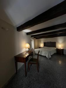 a bedroom with a bed and a desk with a desk at Antica Dimora in Catanzaro