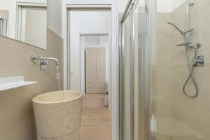 a bathroom with a shower with a sink and a toilet at Villa Cormorani 1 in Golfo Aranci +27 photos