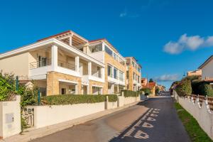a house on a street with a driveway at Villa Cormorani 1 in Golfo Aranci