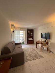 a living room with a couch and a table at Cœur de Nice in Nice