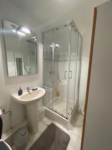 a bathroom with a glass shower and a sink at Cœur de Nice in Nice +19 photos
