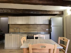 a kitchen with a table and a refrigerator at Antica Dimora in Catanzaro