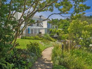 a house with a garden and a pathway at Oaklands On The Knoll by Dream Resorts in Knysna