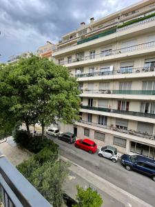 a large building with cars parked in front of it at Cœur de Nice in Nice