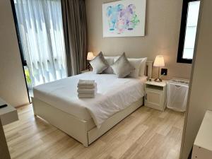 a bedroom with a white bed with towels on it at Halo the Title in Ban Nong Chaeng +50 photos
