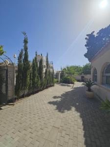 a brick driveway with trees and a building at Costacabana Sea Apartment in Almería