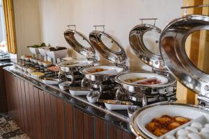 a buffet line with many plates of food at Greenwood Hotel Restaurant & Spa in Batumi