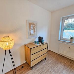 a room with a dresser and a window at Urban Suites HBN in Heilbronn