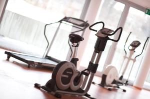 a group of three exercise bikes in a gym at Ramada by Wyndham Dresden in Dresden