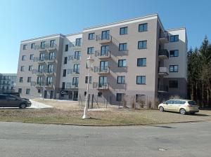 an apartment building with a car parked in front of it at WITH LOVE Marienbad Ap Garden 2 in Mariánské Lázně