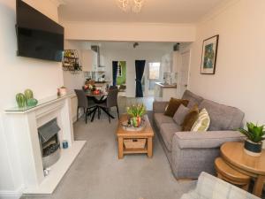 a living room with a couch and a fireplace at The Old Chapel in Scarborough