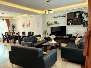 a living room with couches and a dining room at Pensiunea Amarilis in Moieciu de Jos