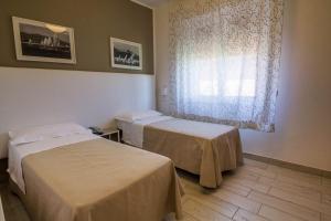 Postel nebo postele na pokoji v ubytování Hotel Mirella