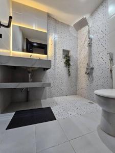 a bathroom with a sink and a toilet at Chez Ebène in Douala