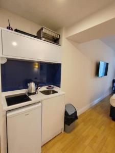a small kitchen with a stove and a sink at Orbi City Simon's studio in Batumi