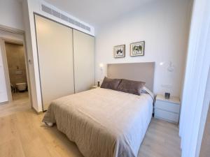 a bedroom with a bed and a large mirror at Malberry Park 201 - Modern 2 Bedroom Apartment with Pool, Gym, Jaccuzi in Paphos City +19 photos