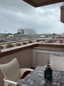 a table and chairs on a balcony with a view of a city at Apartamento 3 habitaciones en la playa de Magic World , Oropesa del Mar in Cabanes