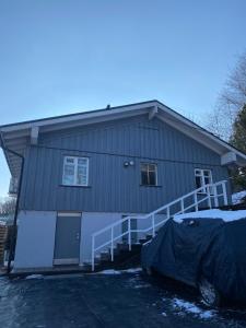een huis met een veranda en een garage bij Small house in Vilnius