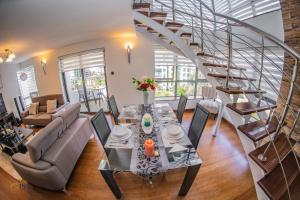 a living room with a table and a staircase at The Lofts on Wood Avenue in Nairobi