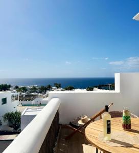 a table on a balcony with a view of the ocean at Canaryislandshost I Dalia in Puerto del Carmen