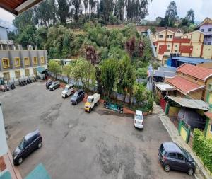 a group of cars parked in a parking lot at Hotel Glanton Manor in Ooty