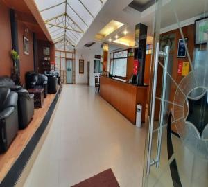a lobby of a hospital with couches and chairs at Hotel Glanton Manor in Ooty +47 photos