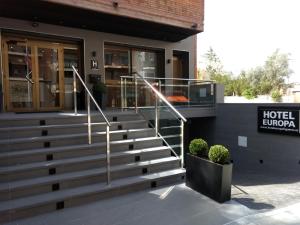 a hotel lobby with stairs in front of a building at Hotel Europa in Figueres