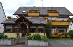 a house with a porch and stairs in front of it at Seestern in Uhldingen-Mühlhofen +5 photos